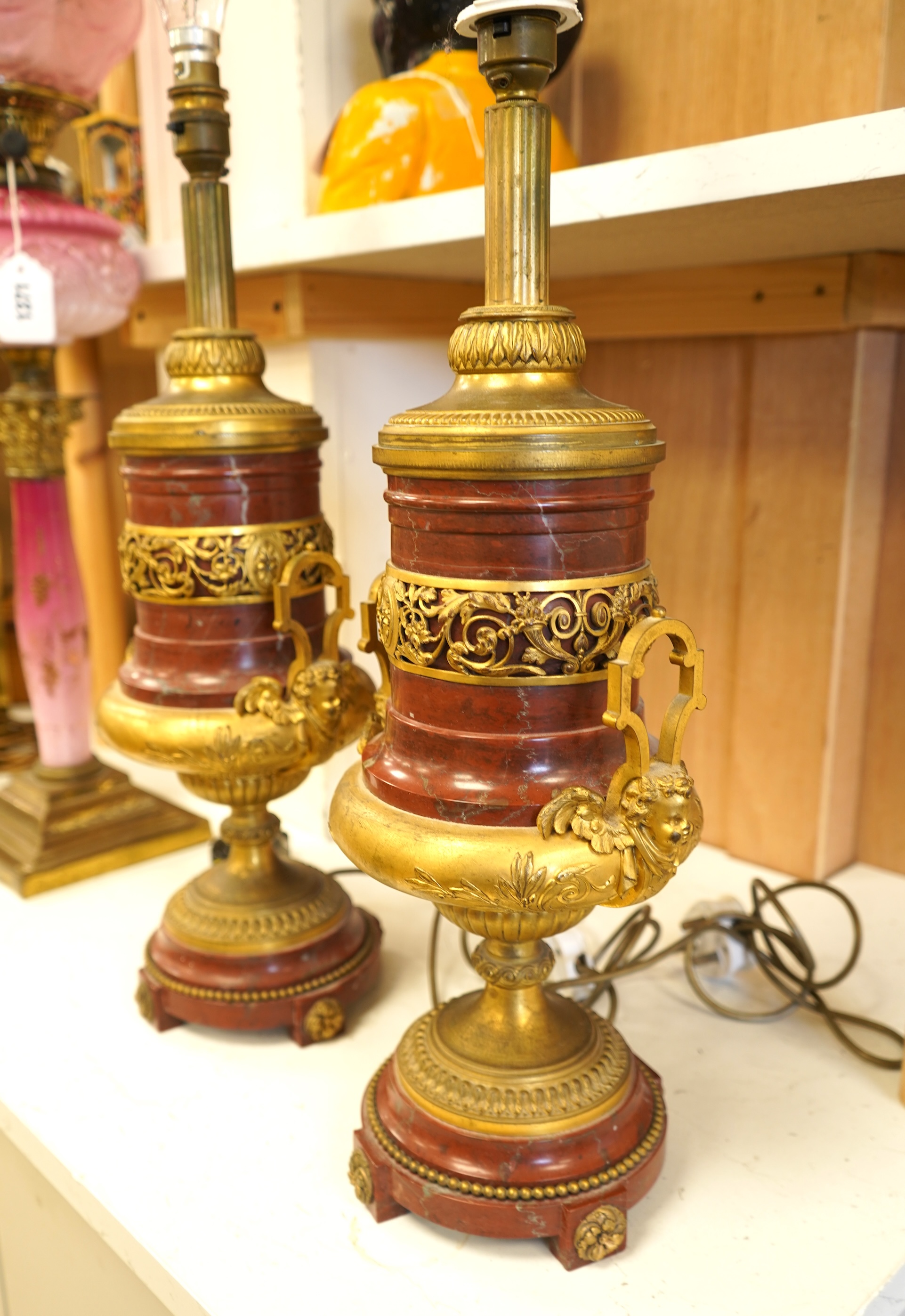 A pair of Empire style gilt metal and rouge marble table lamps, 50cm